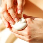 Applying a smooth hand cream Manufacturer product to nourish and hydrate skin.