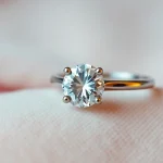 Showcasing a dazzling 2 carat engagement ring with a brilliant cut diamond set on a delicate band, emphasizing luxury.